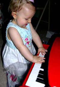 Eva at her new piano. ©Susan Shie 2005.