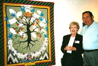 Betsy Cave and husband John, with Betsy's quilt.