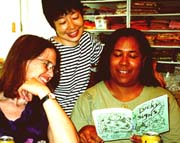 Tomasita reads my Lucky Signs book to Judy and Yoshiko.©Susan Shie 2001.